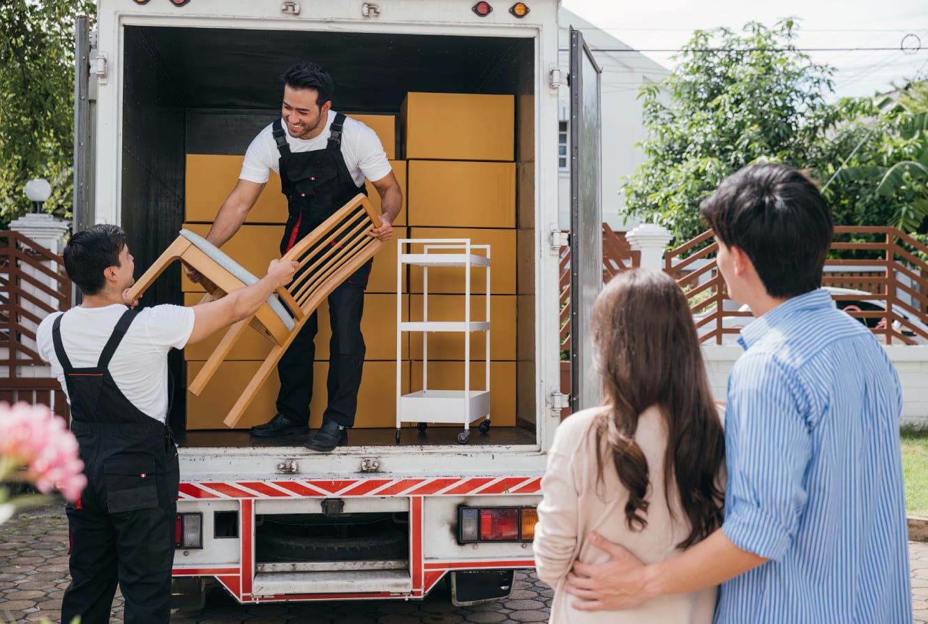 Delivery men removing furniture from a delivery truck
